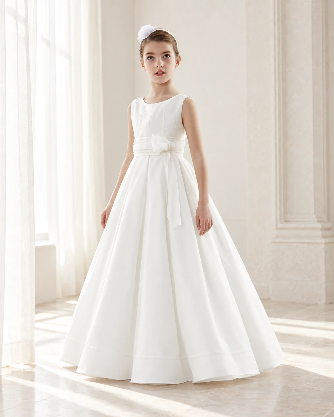 Girl wearing a simple white First Communion dress